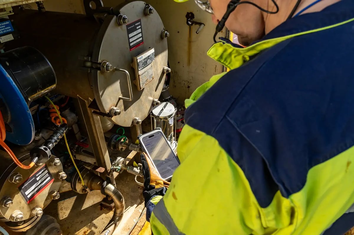 Technician checking an Ex enclosure nameplate with an explosion-proof iPhone in Zone 1