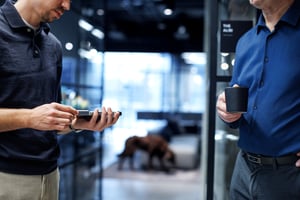 Two Xshielder engineers discussing the product over a cup of coffee at our office in Stavanger